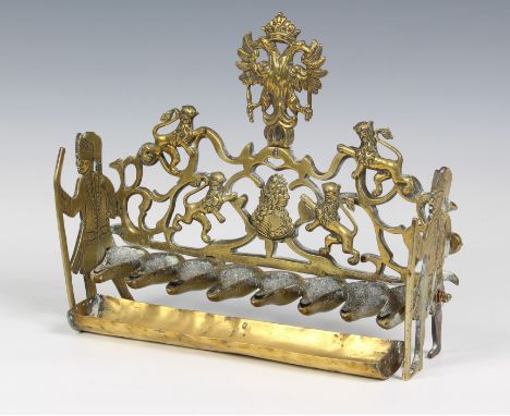 An Eastern European hanukah lamp, probably early 20th century, the pierced back decorated with a double headed eagle and a mo