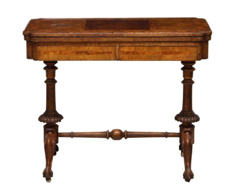 An early Victorian walnut folding card table, the inlaid chamfored top over two frieze drawers with turned and gadrooned end 