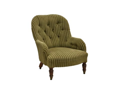 A Victorian easy armchair in olive green upholstery, with a buttoned back and serpentine stuff over seat, raised on turned le