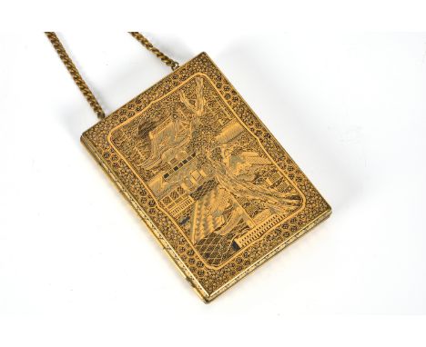 A Japanese gilt metal and niello compact in the style of Komai, 1920s-30s, the exterior decorated with two dragons and a pala