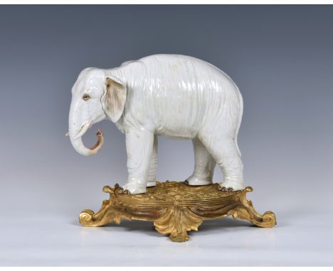 An ormolu mounted Sampson white porcelain elephant , after Meissen, 19th century, realistic features, modelled standing upon 