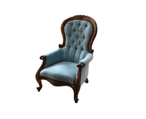 A Victorian style mahogany showframe armchair, the crested top rail over an upholstered button back and arms, with a serpenti