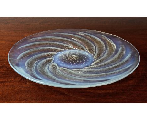 A Rene Lalique opalescent 'Poissons' dish, with spiraled fish around central air bubbles, 'R. Lalique' signed to base, 12 3/8
