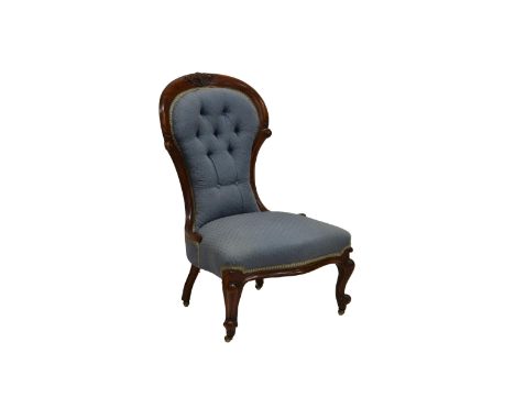 A Victorian walnut showframe nursing chair, the crested top rail and scroll carved uprights supporting a buttoned back, the s