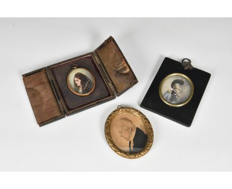 Three 19th and early 20th century portrait miniatures, one a profile miniature of a gentleman, oval, watercolour, 3 1/8 x 2½i