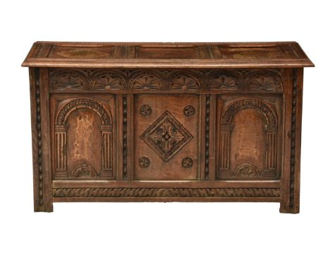 A 19th century carved oak three panel coffer, in the late 17th century style, the front  with three ornate carved panels comp