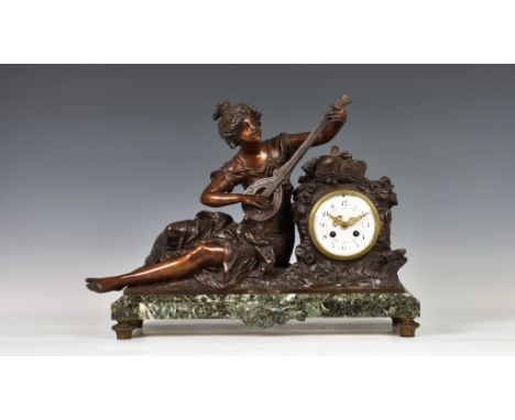 A French bronzed spelter and marble mantel clock, late 19th century, the figure of a seated female musician after Moreau, wit