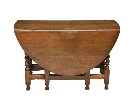A 17th century and later English oak gate leg oval table, with two demi lune drop leaves over a single frieze drawer, (altera