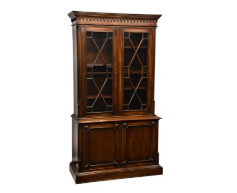 A reproduction late Georgian / early Victorian style mahogany glazed library bookcase, the flared top over two thirteen pane 