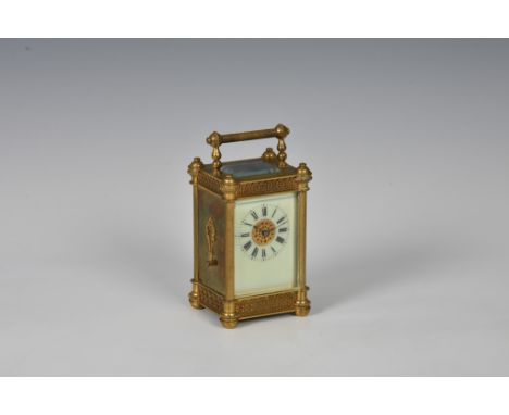 A French miniature gilt brass carriage timepiece, late 19th century, the ornate column case with applied ovolo masks to the f