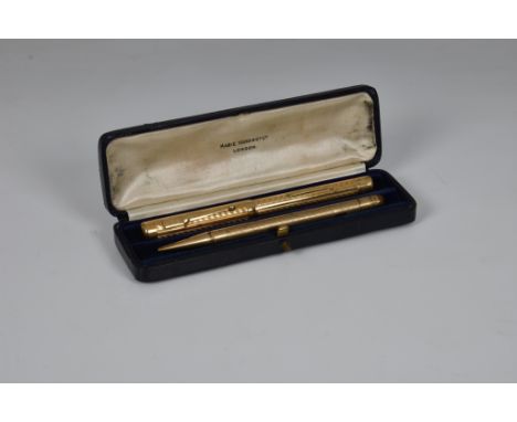 A rolled gold Mabie Todd Swan Pen lever filling fountain pen, engine turned chevron decoration, no.2 nib, VG; together with a