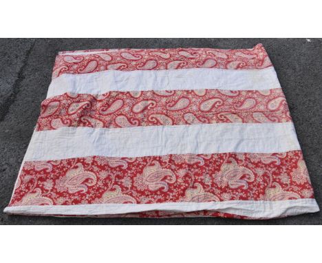 A vintage bed throw, having white and paisley striped detail on red ground, 100 x 84in., together with a patchwork measuring 