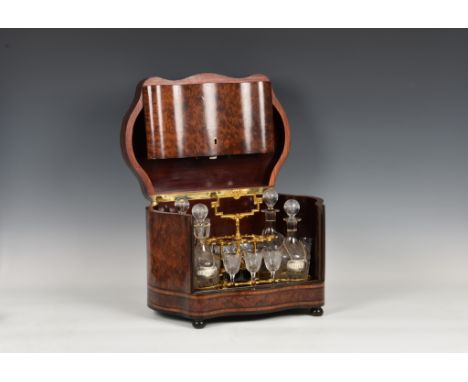 A French Napoleon III burr amboyna, ebonised and brass cave a liqueur, c.1870, the serpentine shaped tantalus with boulle, br