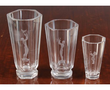Three graduated art glass vases by Orrefors of Sweden, of hexagonal tapering form, featuring a single etched figure of a youn