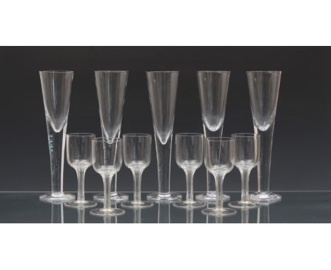 A set of five unusual oversized blown glass champagne flutes, probably third quarter 20th century, of drawn trumpet form, on 