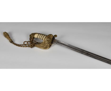 A late Victorian Naval dress sword, with wire bound shagreen handle, lion pommel and brass hand guard, with an engraved 81cm.