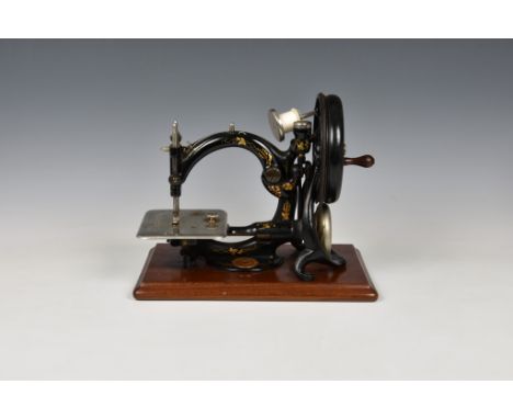 An early Willcox &amp; Gibbs Sewing Machine, with original carrying box. Serial number A494338 denoting that it was made in t