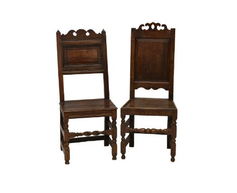 Two 17th century oak chairs, one having twin finials with a fielded panel below, turned legs and twist turned stretcher the o