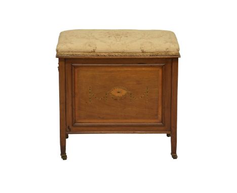 An Edwardian mahogany piano stool, the stuff over seat lifting to a three compartment interior for music storage, the single 
