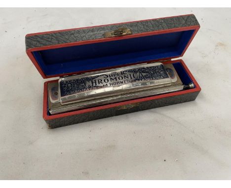 A BOXED HOHNER 'THE SUPER CHROMONICA' HARMONICA 