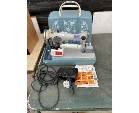 A RETRO JONES SEWING MACHINE WITH WORK LIGHT, FOOT PEDAL AND CARRY CASE 
