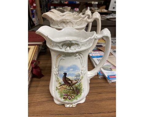 A SET OF FOUR VINTAGE JUGS WITH PHEASANT DECORATION - RUBBING TO THE GILDING HEIGHT THREE AT 21CM AND ONE AT 19CM 