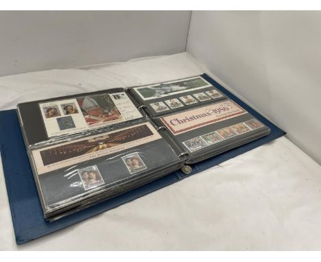 AN ALBUM CONTAINING FIRST DAY COVER STAMPS 
