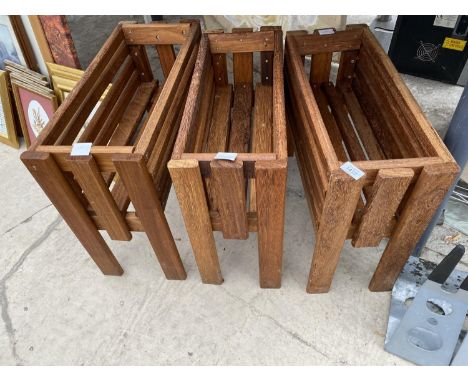A SET OF THREE WOODEN TROUGH PLANTER HOLDERS 
