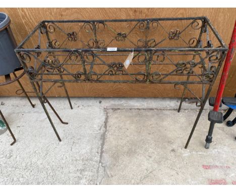 A DECORATIVE WROUGHT IRON PLANT STAND 