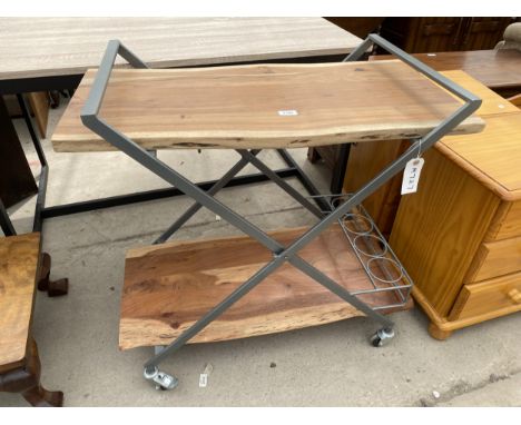 A MODERN METAL FRAMED TROLLEY WITH FOUR BOTTLE STAND HAVING TWO TIERS OF RUSTIC WOOD 