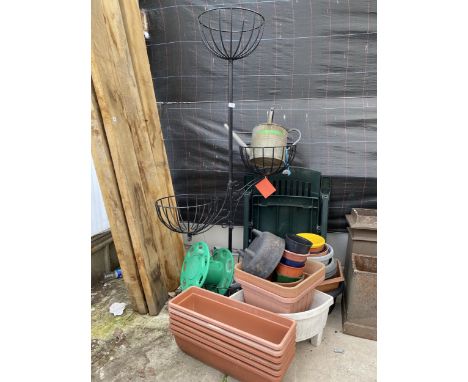 A COLLECTION OF GARDEN PLANTERS AND A TIERED PLASTIC COVERED METAL STAND WITH FOUR BASKETS 