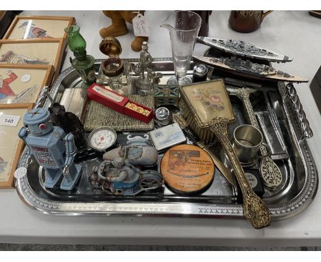 A SILVER PLATED TRAY CONTAINING A VARIETY OF COLLECTABLES TO INCLUDE TIN  PLATE TOYS, MIRROR AND BRUSH SET, GLASS INKWELL, FI