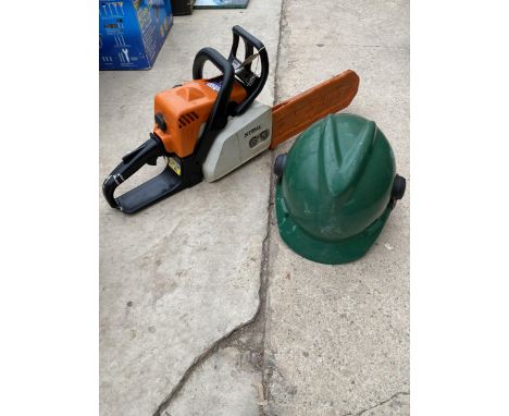 A STIHL PETROL CHAINSAW WITH A HARD HAT 