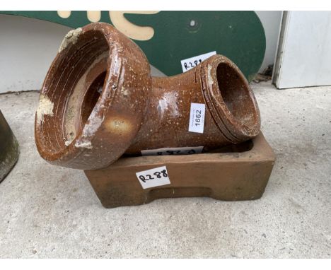 A SHALLOW SQUARE TERRACOTTA DISH AND A GLAZED DRAIN PIPE 