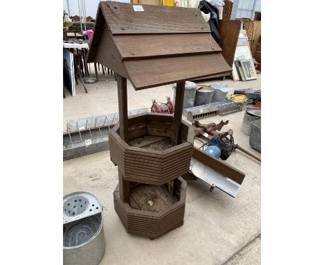 A WOODEN WISHING WELL PLANTER 