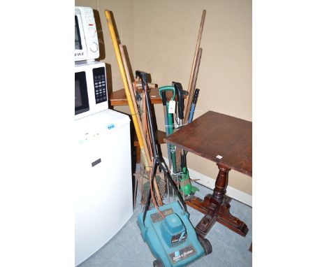 A Black & Decker lawn mower; together with a quantity of garden tools.