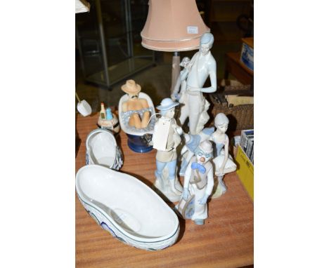 A Nao lamp in the form of a clown standing beside a tree trunk; and four other Spanish ware figures various; two 'Indian Tree