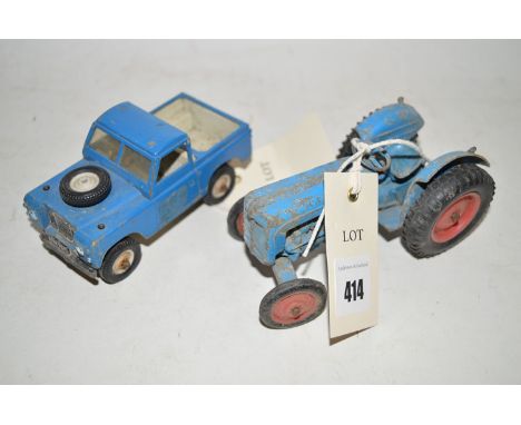 Two die-cast model vehicles, a Fordson Tractor, and a Land Rover pick-up.