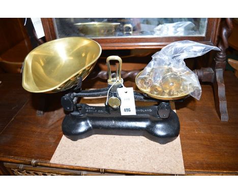 A pair of brass and metal kitchen scales; together with a set of brass weights.