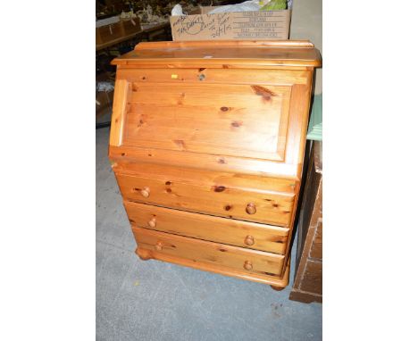 A modern pine bureau; an open bookcase; and a mahogany lamp table.