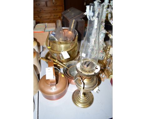 A coal scuttle; a copper kettle; a set of three graduating copper pans with brass handles; a brass oil lamp with several glas