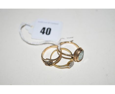 A diamond cluster ring in illusion setting, on yellow metal shank stamped '18ct'; a three-stone sapphire set ring; and anothe