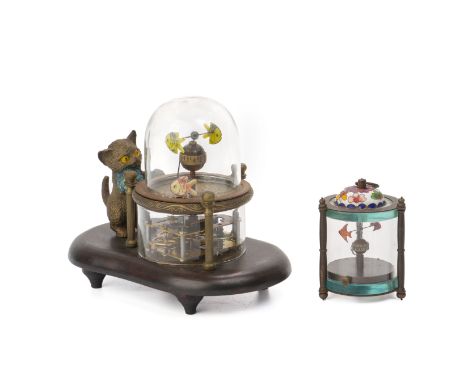 TWO NOVELTY MECHANICAL CLOCKS
The larger with a cat peering into a glass dome, with fish, both with manual wind movements, la