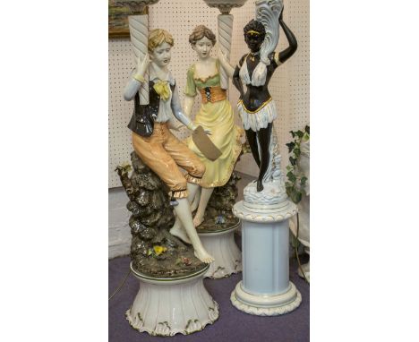 FIGURAL LAMPS, a companion pair, Capodimonte manner ceramic of a boy and girl, each on a stand and another modelled as a blac