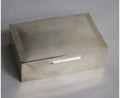 A George VI engine turned silver rectangular cigarette box, W.H. Manton Ltd, Birmingham, 1950, 14cm.