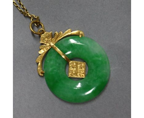 A yellow metal mounted jade disc pendant on 9ct gold fine chain 25mm.