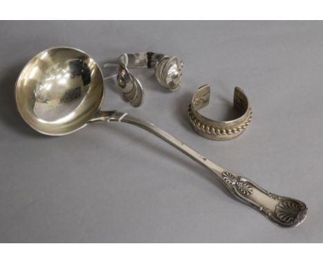 An American silver shell-pattern soup ladle, Makers R & W Wilson, Philadelphia and two white metal bangles.