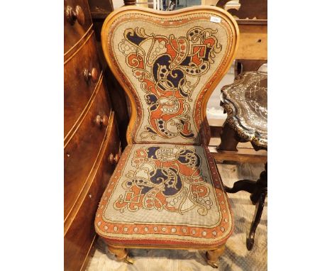 Tapestry upholstered chair on turned supports with brass castors