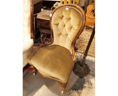 Antique button back upholstered chair with ivory castors