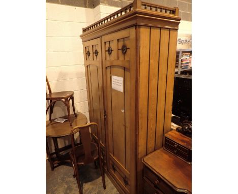 Art Deco light oak wardrobe with carved roses and galleried top with large central lower drawer to interior W: 127 cm H: 216 